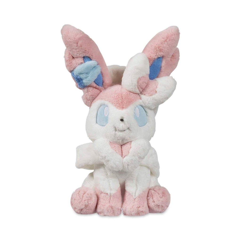Sylvia Sylveon Comfy Friends plush officially licensed Pokémon Eevee evolution stuffed animal. Ultra-soft premium chenille fabric cloud-like texture sensory comfort toy. Pastel pink coloring safety embroidered eyes perfect for emotional support anxiety relief. Comfy Friends collection limited edition Pokémon Center product. Best gift for Pokémon fans children adults birthday Christmas present. Huggable design soft stuffed toy collectible merchandise cuddling companion.